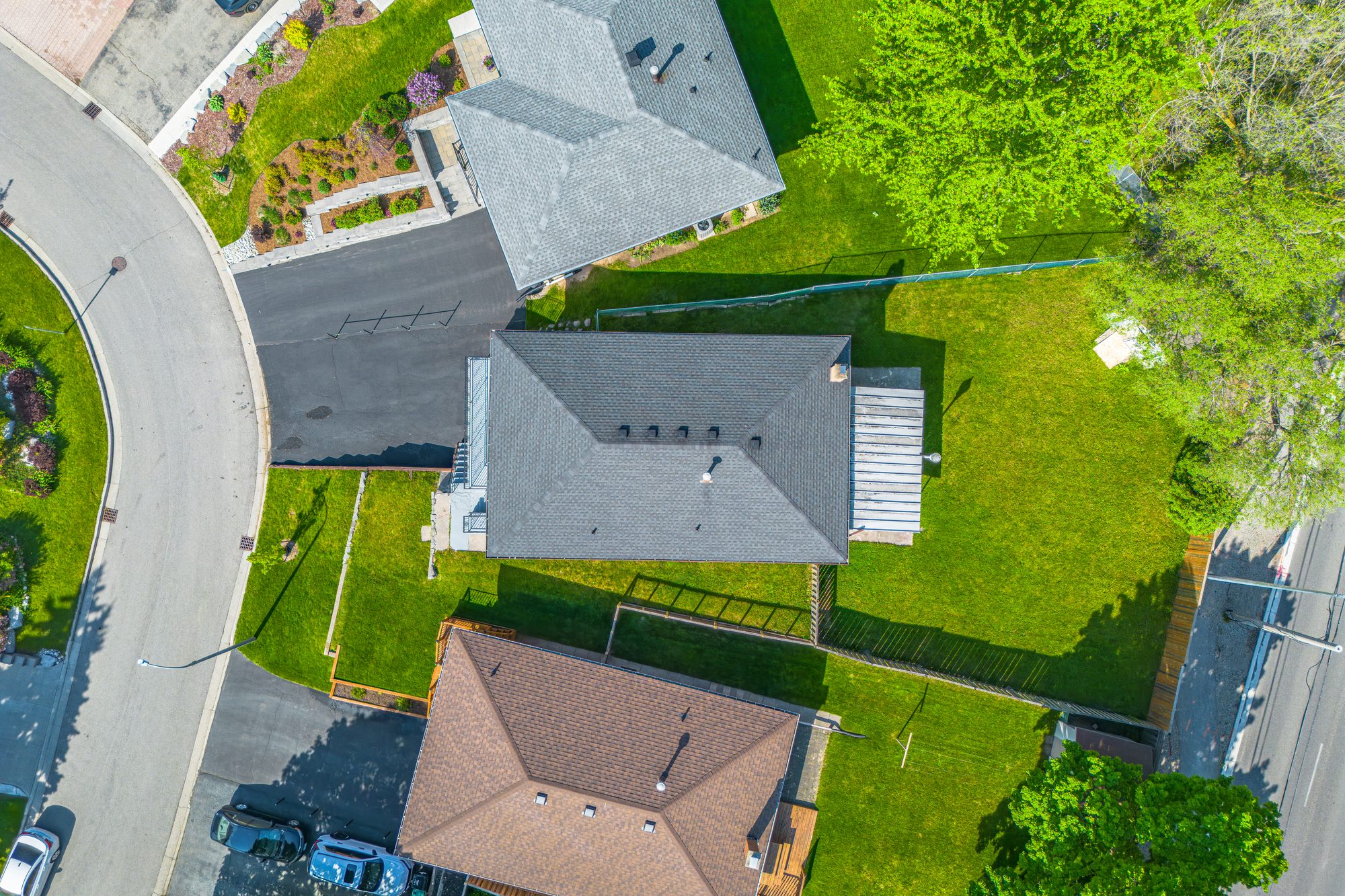 Aerial drone view of a property, lot and surrounding neighbourhood
