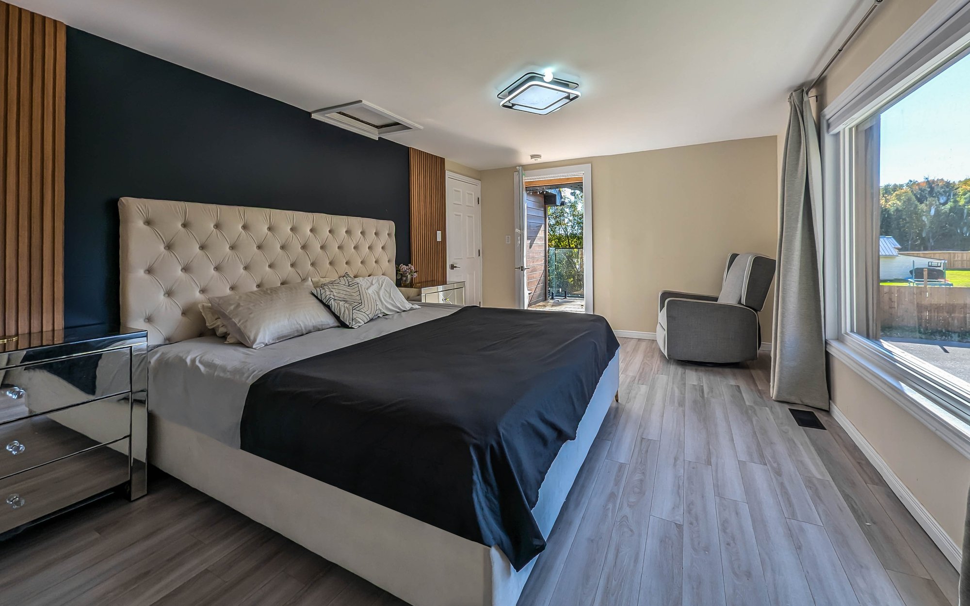 Cinematic shot of a modern master bedroom with dark accent wall