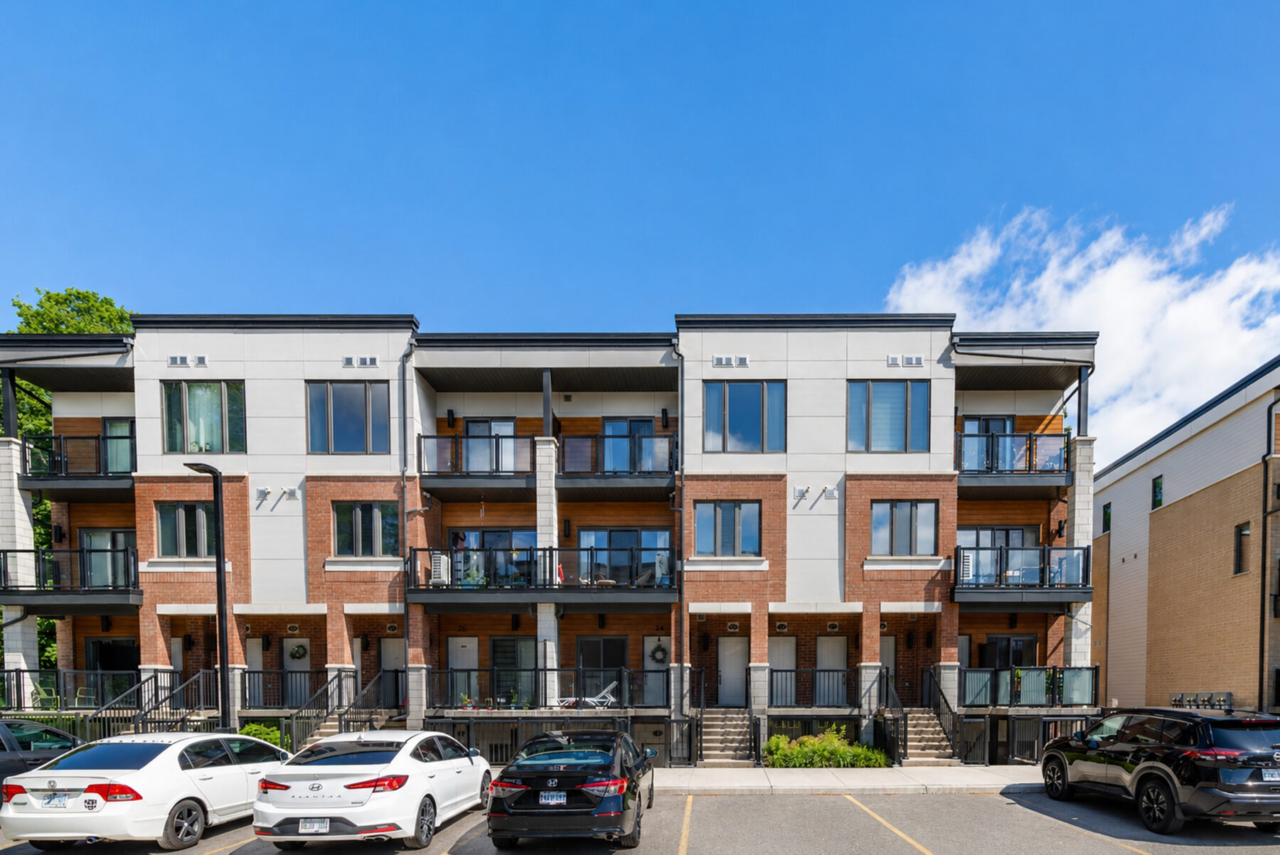 Modern townhome exterior with clean blue sky